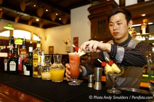 THE MAKING OF THE FAMOUS SINGAPORE SLING COCKTAIL AT THE RAFFLES HOTEL IN SINGAPORE